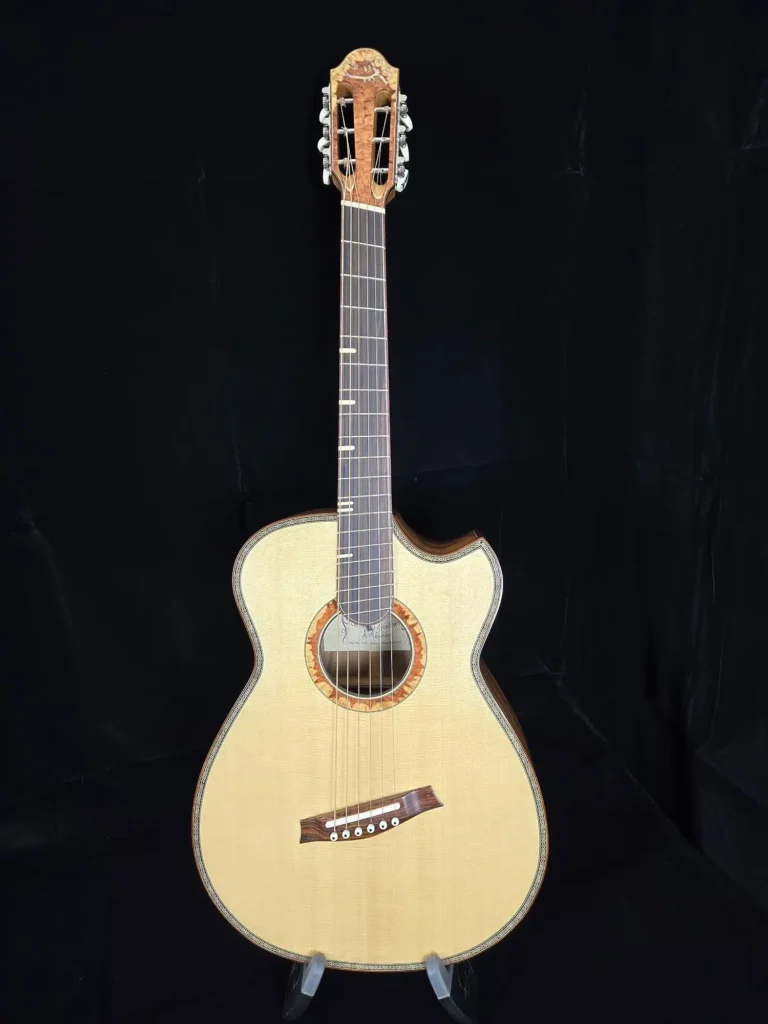 Full front view of a classical acoustic guitar with light wood top and slotted headstock.