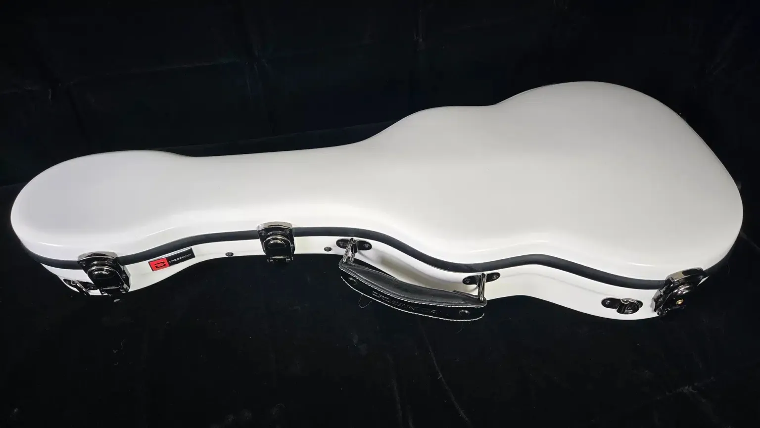 Closed white hardshell ukulele case with black trim, metal latches, and a carry handle.