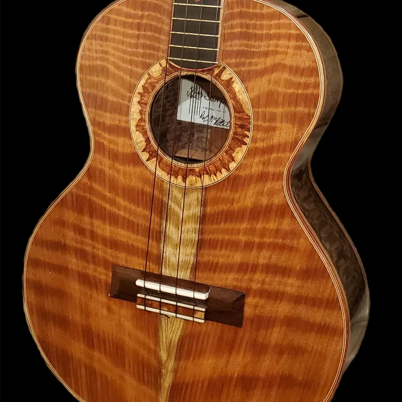 Front view of a custom ukulele with a flamed wood top, decorative rosette, and dark fingerboard.