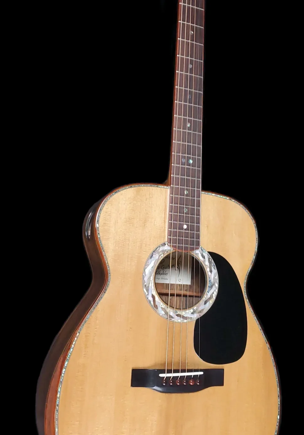 Full front view of an acoustic guitar with light wood top, dark pickguard, and decorative rosette.